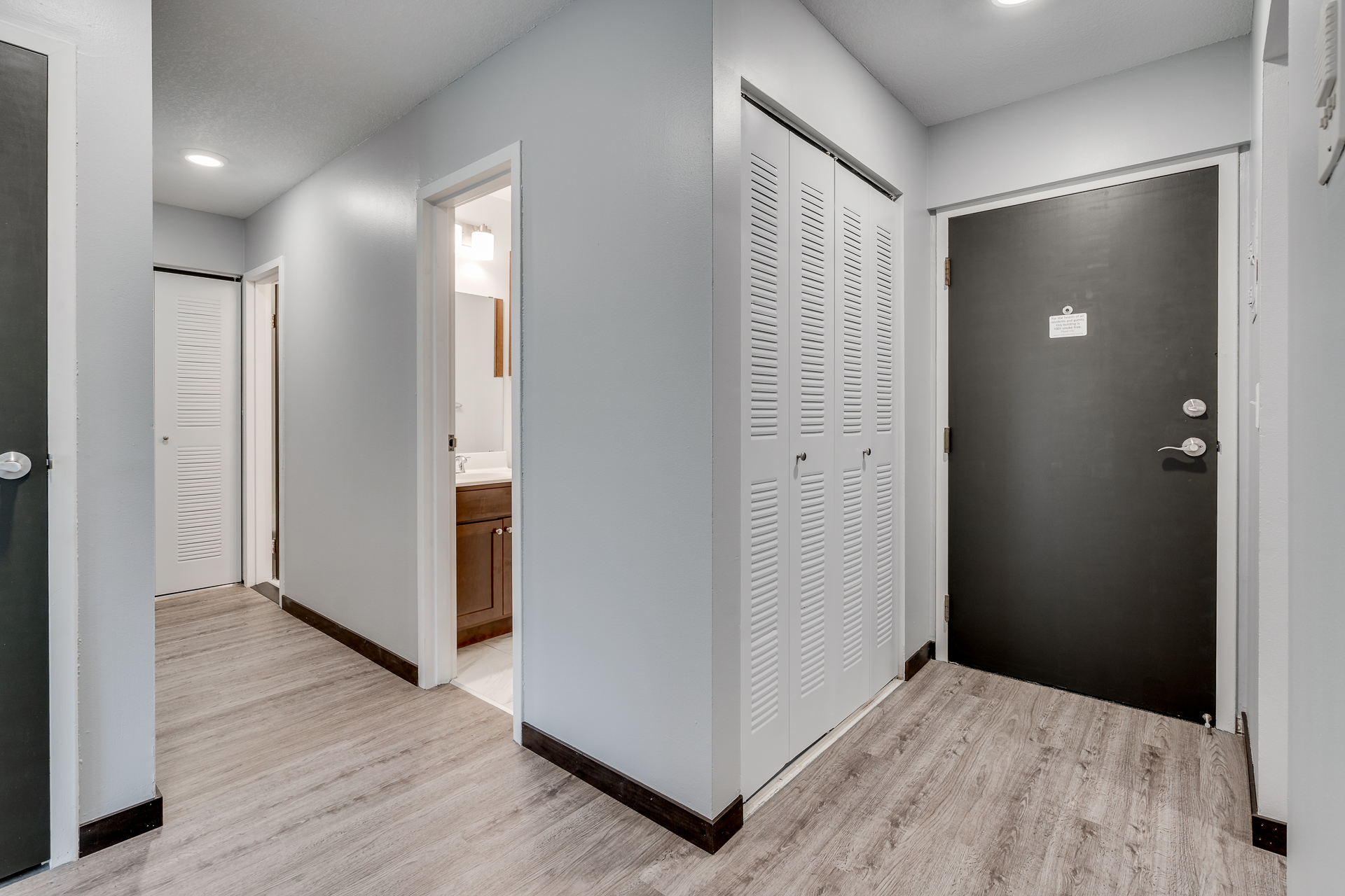 Entry way with view of closets and bathroom