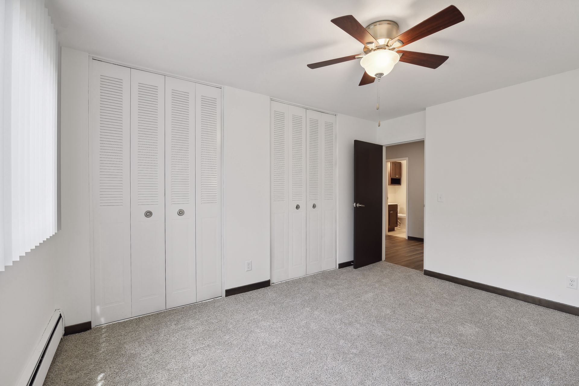 Bedroom with two large closets and a ceiling fan