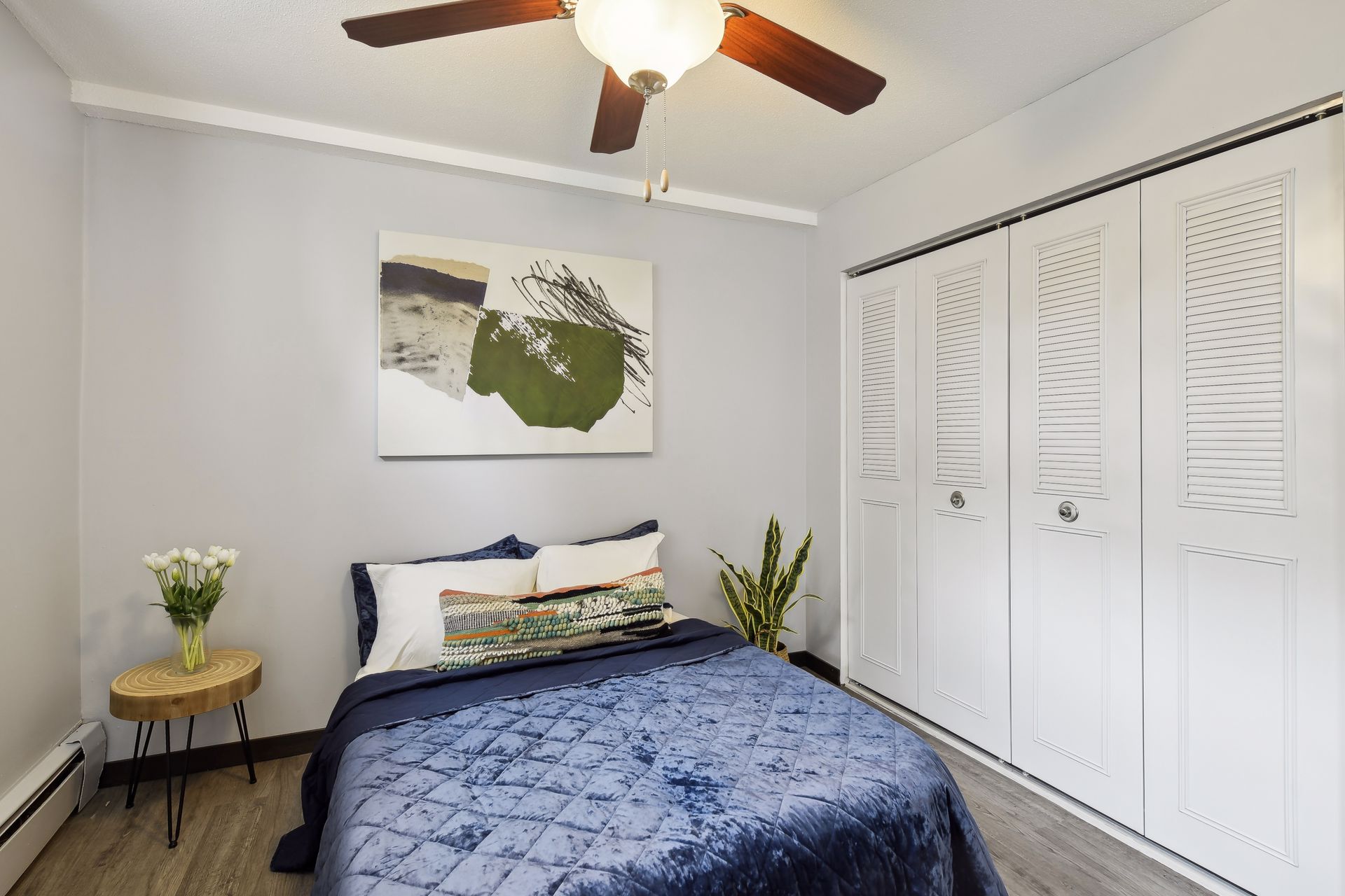 Furnished bedroom with a ceiling fan